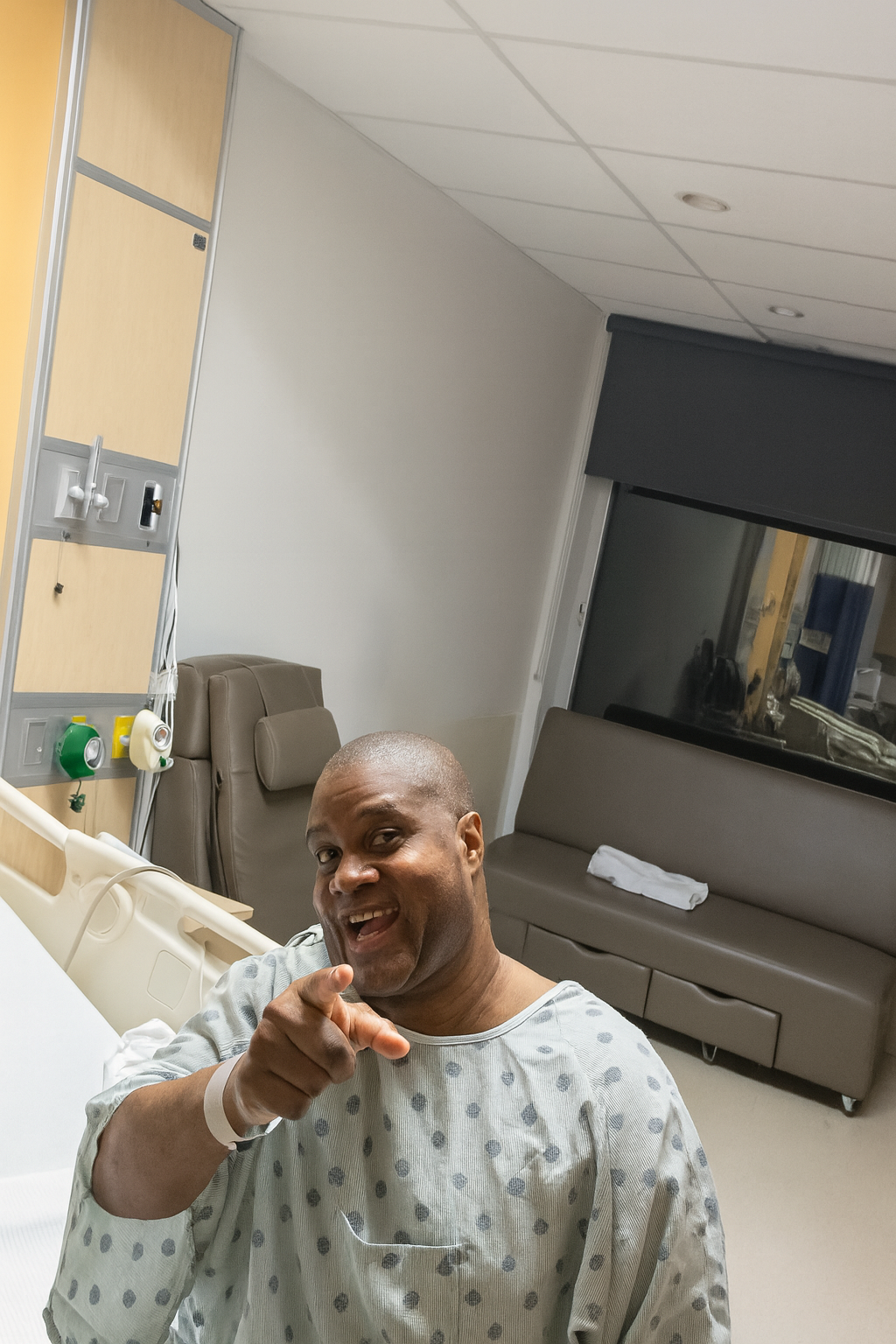 Mark in a hospital gown during recovery